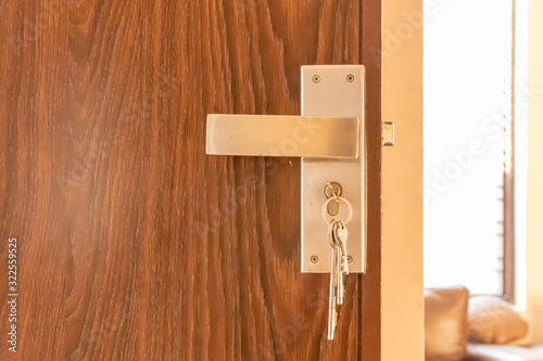 Door lock handle with set of keys hanging with door