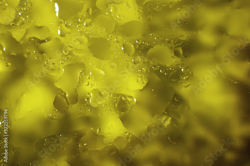 water drops on a yellow background. Abstract yellow background. Water drops on glass.