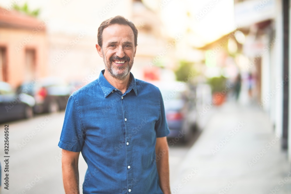 Middle age handsome man standing on the street smiling Middle age handsome man standing on the street smiling