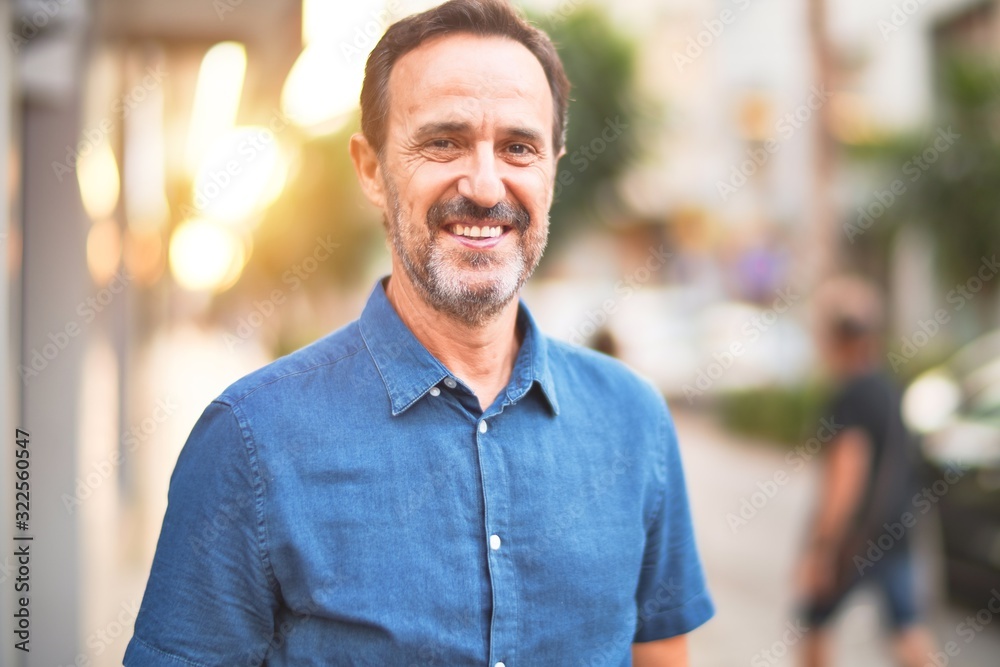 Middle age handsome man standing on the street smiling Middle age handsome man standing on the street smiling