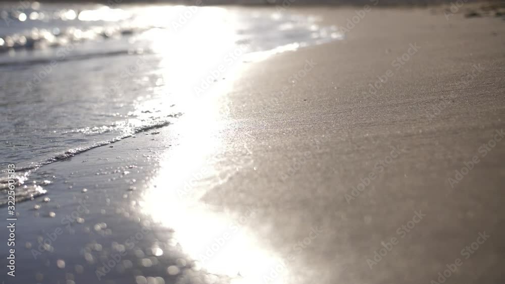 waves on the beach at sunset in Spain, waves with foam slow motion waves on the beach at sunset in Spain, waves with foam slow motion