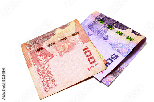 Thai banknotes in the amount of 100 baht and 500 baht. Fold overlapping on a white background.