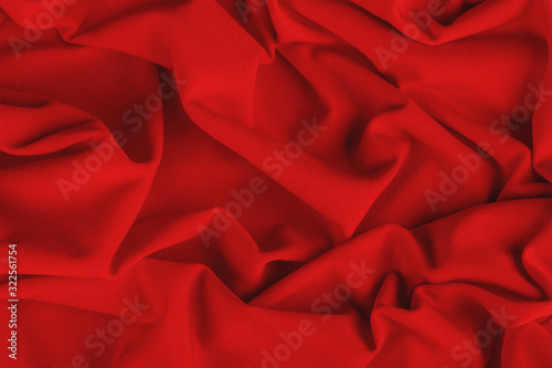 Smooth elegant red draped fabric. Background, texture.