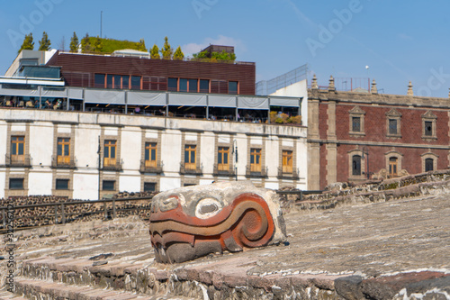 Fragment of Greater Temple (Templo Mayor) with Kukulkan (Feathered Serpent) head. Detail of ancient aztec ruins. Travel photo. Mexico city. photo