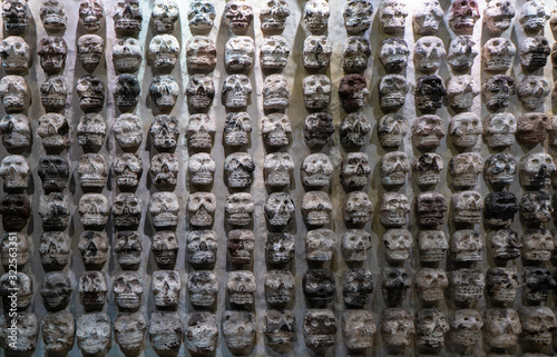 Fragment of Greater Temple (Templo Mayor). Skull Rack. Detail of ancient aztec ruins. Travel photo. Structure of old walls. Mexico city. photo