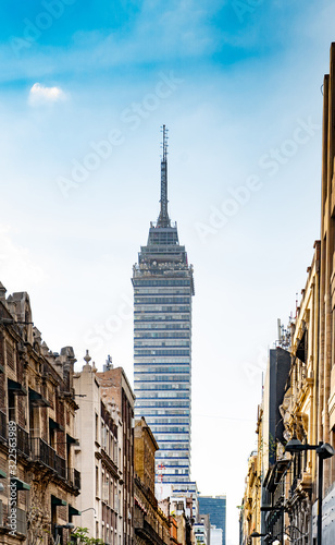 Tower of latino americano with blue sky background. Fragment of Mexico city architecture. Famous landmark. © Viktoras