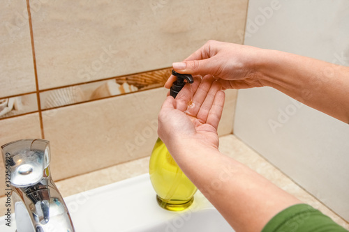 A Washing hands with soap under the faucet with water