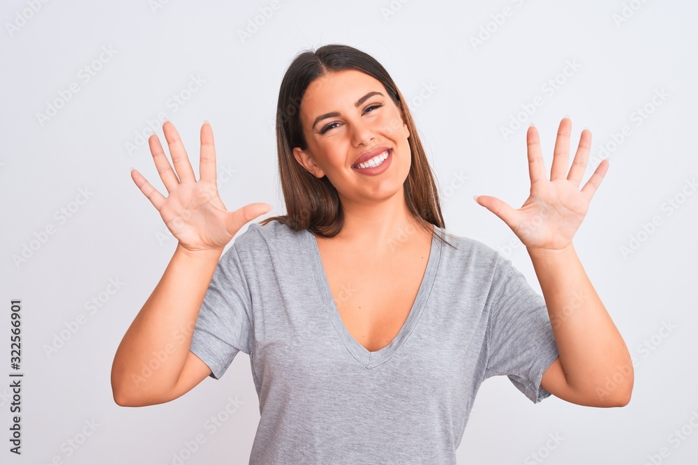 Portrait of beautiful young woman standing over isolated white background showing and pointing up with fingers number ten while smiling confident and happy. Portrait of beautiful young woman standing over isolated white background showing and pointing up with fingers number ten while smiling confident and happy.