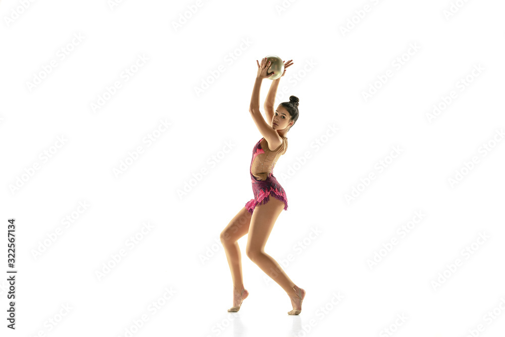 Young flexible girl isolated on white studio background. Teen-age female model as a rhythmic gymnastics artist practicing with equipment. Exercises for flexibility, balance. Grace in motion, sport. Young flexible girl isolated on white studio background. Teen-age female model as a rhythmic gymnastics artist practicing with equipment. Exercises for flexibility, balance. Grace in motion, sport.