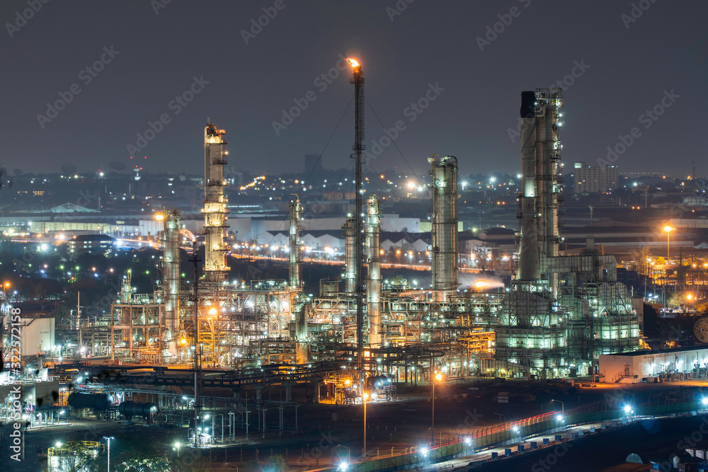 Oil refinery factory and oil storage tank at twilight and night. Petrochemical Industrial