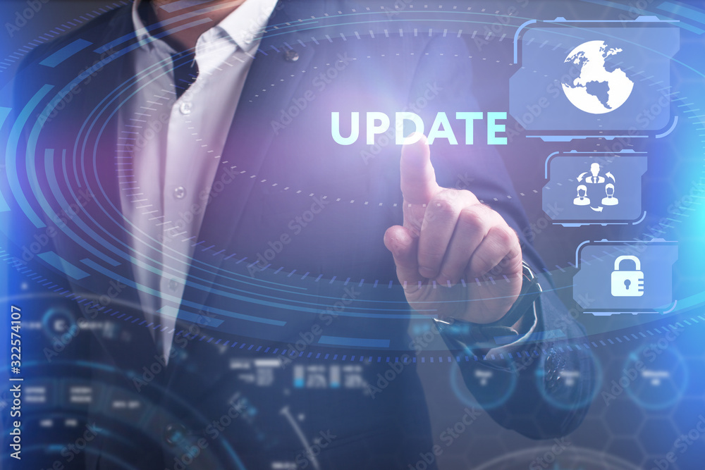 Obraz premium Business, Technology, Internet and network concept. Young businessman working on a virtual screen of the future and sees the inscription: Update