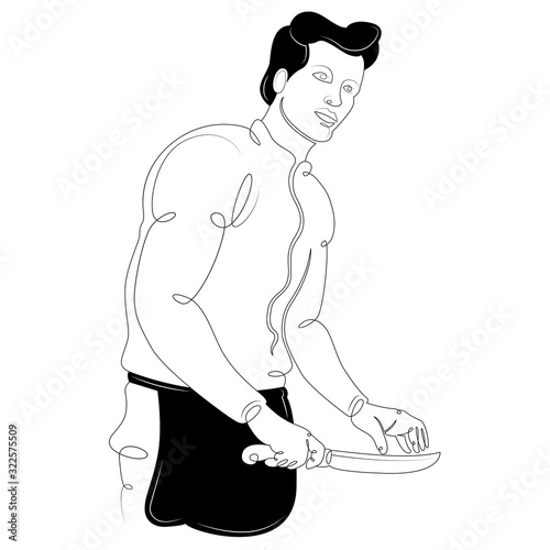 Male cook in a black apron. The chef cuts with a knife.