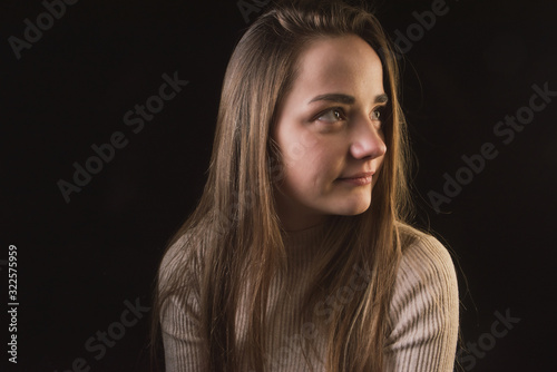 impulsive girl with light hair on a dark background, portrait of a girl with large facial features