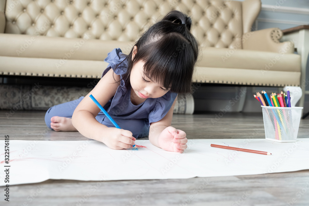 Beautiful Asian child girl lying and drawing with color pencils at home Beautiful Asian child girl lying and drawing with color pencils at home