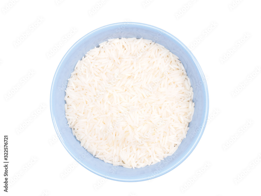 Indian long grain Basmati rice in blue ceramic bowl isolated on white. Indian cuisine, ayurveda, naturopathy concept Indian long grain Basmati rice in blue ceramic bowl isolated on white. Indian cuisine, ayurveda, naturopathy concept