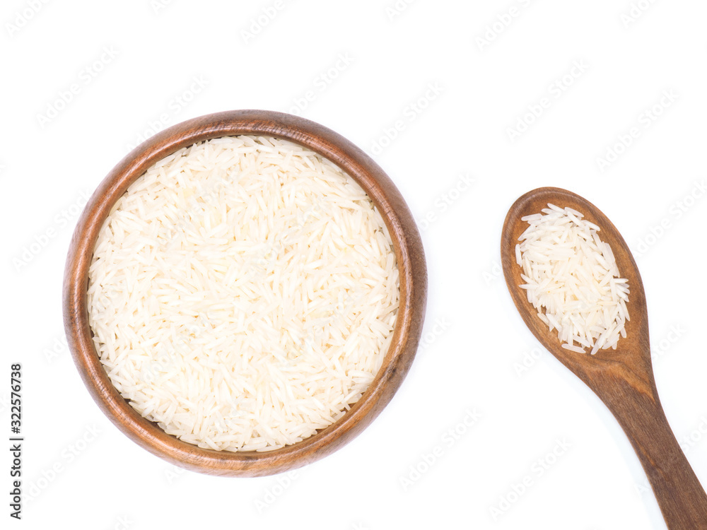Indian long grain Basmati rice in brown wooden bowl and spoon isolated on white. Indian cuisine, ayurveda, naturopathy concept Indian long grain Basmati rice in brown wooden bowl and spoon isolated on white. Indian cuisine, ayurveda, naturopathy concept