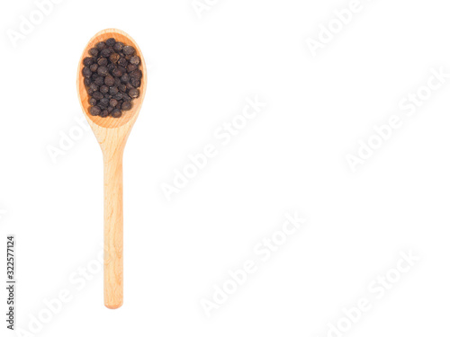 Spice black pepper in wooden spoon isolated on white