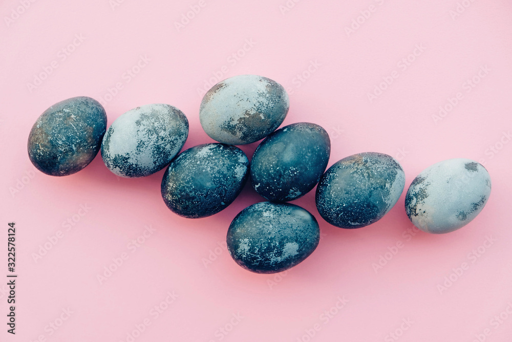 Natural dyed blue colored eggs on pastel pink background. Natural dyed blue colored eggs on pastel pink background.