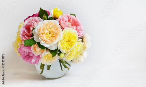 Bouquet of flowers  on white background. Roses on glass round vase  celebration concept
