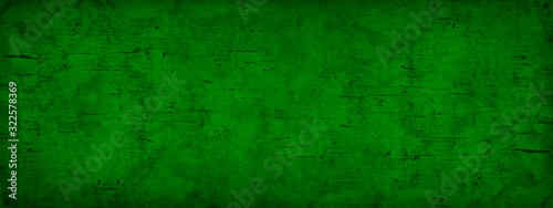 Abstract green grunge background. Toned old stained wood background. Green vintage banner. Copy space for your design.