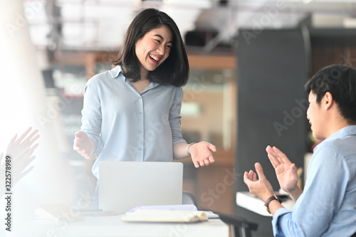 Business development team applauding to them boss while they finished discussing/meeting at the modern meeting table with comfortable meeting room as background.
