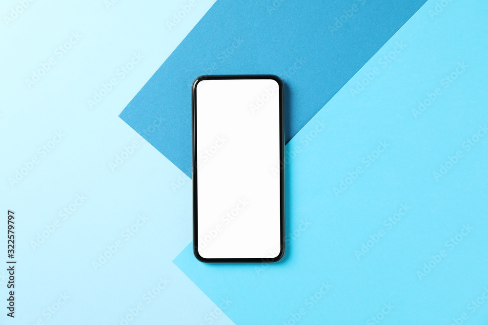 Phone with empty screen on three tone background, top view Phone with empty screen on three tone background, top view