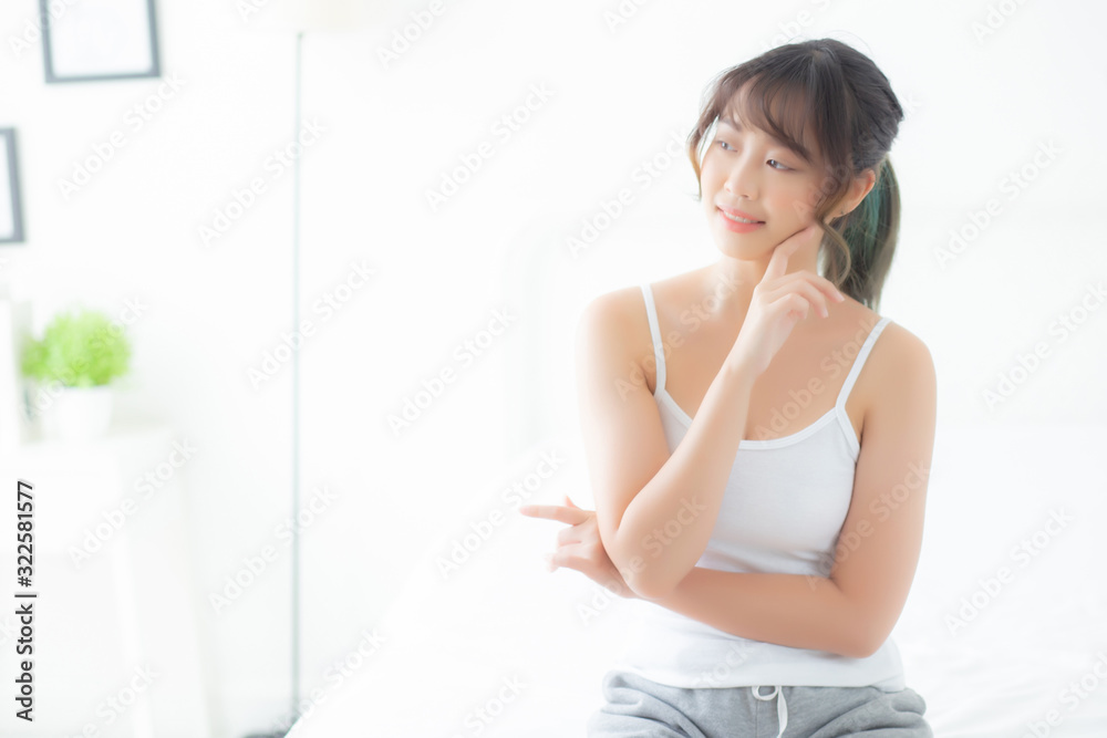 Portrait of beautiful young asian woman smile while wake up healthy and wellness with sunrise at morning in the bedroom, asia girl skin care with happy with fresh, lifestyle and relax concept. Portrait of beautiful young asian woman smile while wake up healthy and wellness with sunrise at morning in the bedroom, asia girl skin care with happy with fresh, lifestyle and relax concept.