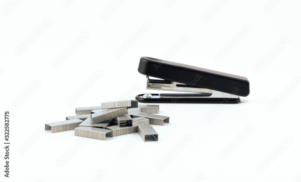 Black stapler and metal staple isolated on a white background. Office Equipment and Work Tool concept Design. Black stapler and metal staple isolated on a white background. Office Equipment and Work Tool concept Design.
