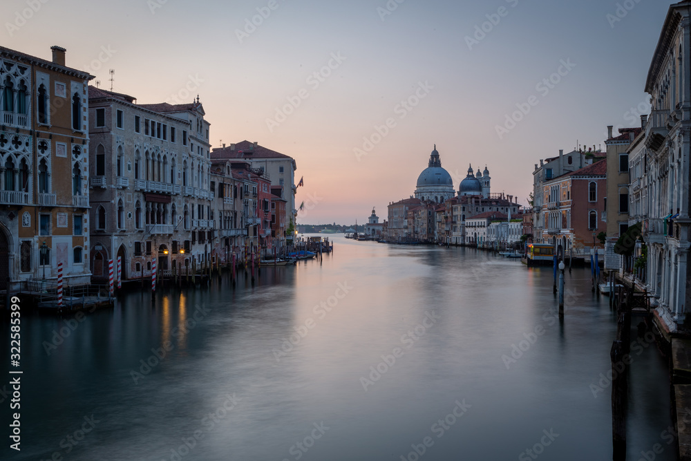 Grand Canal from the Accademia bridge with basilica Saint Mary of Health (Basilica di Santa Maria della Salute) at dusk sunset sunrise in Venice, Italy
