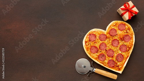 Valentine's day arrangement with heart shaped pizza and copy space