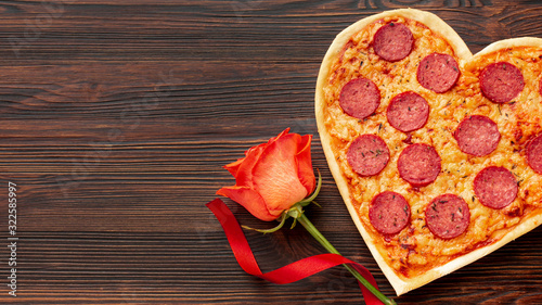 Lovely arrangement for valentines day dinner with heart shaped pizza and rose