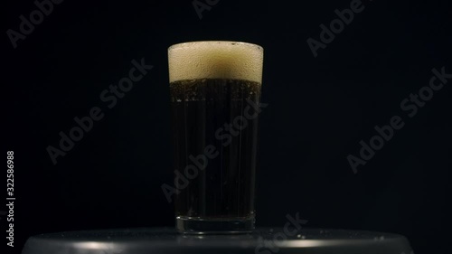 Cold cola with ice in a tall transparent glass