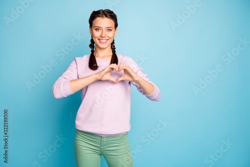 Portrait of her she nice attractive lovely cheerful cheery girlfriend showing heart gesture care isolated bright vivid shine vibrant blue green teal turquoise color background