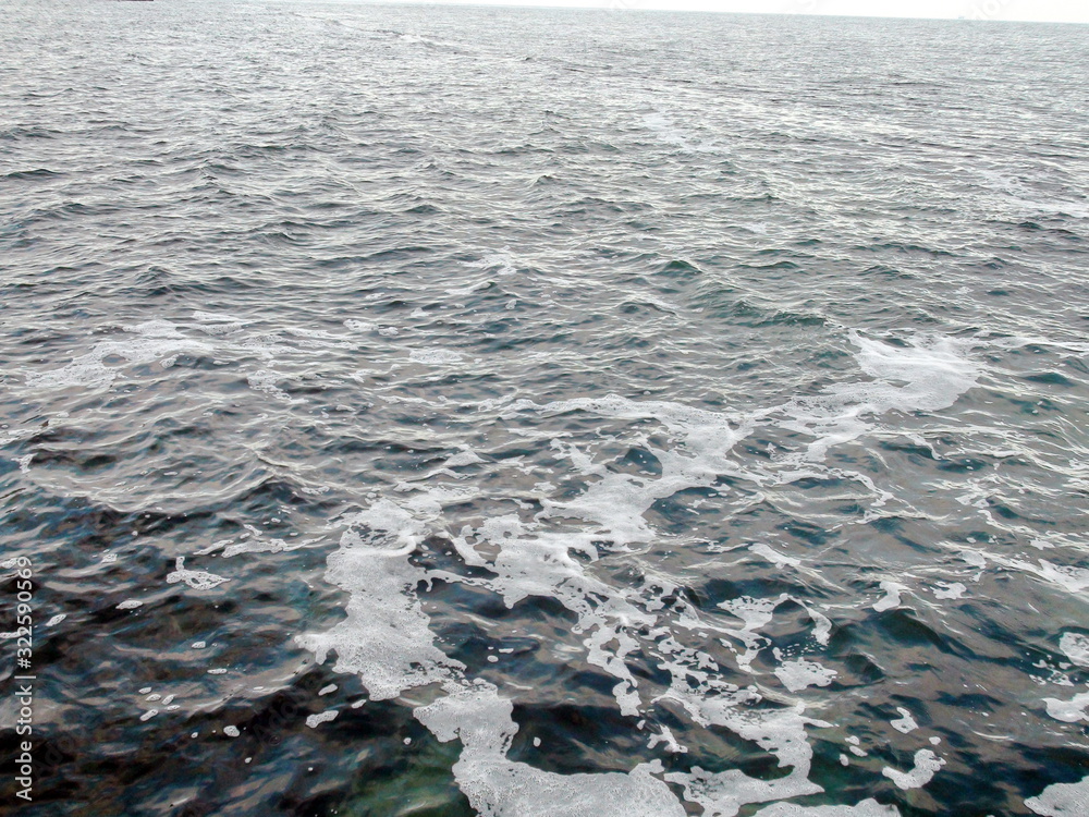 Landscape of stormy sea surface covered with foam and endless ripples. Landscape of stormy sea surface covered with foam and endless ripples.