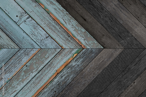 Black and blue wooden wall with herringbone pattern made of barn boards. Old weathered wood texture for background.  