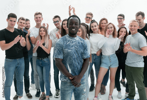 happy guy standing among a group of his friends