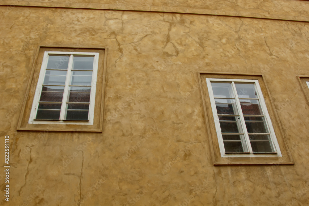 Prague, Czech Republic. 10.05.2019: Detail of the yellow facade of a historic building in the old town of beautiful Prague, Czech Republic. Golden hourly photograph. The sun shines on the facade.