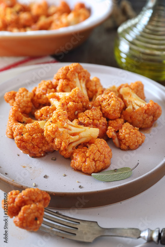 Vegetarian cuisine: spicy roasted cauliflower in tomato sauce and olive oil