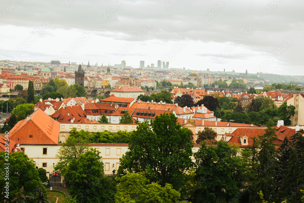 Prague. 05.10.2019: Orange colored roof tops of Prague old town buildings and baroque style houses viewed from top of old town hall tower, Prague, Czech Republic. Panorama. - obrazy, fototapety, plakaty 