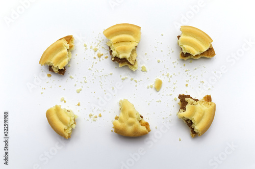 Sandwich cookies filled with coffee cream flavored. Some broken and crumbs of crunchy delicious sweet meal and useful cookie on white background.