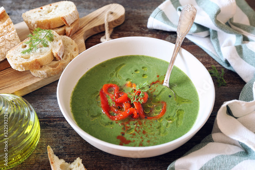 Green pea soup with spinach, olive oil, red grilled bell pepper and dill dressing