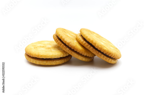 Biscuit sandwich cracker chocolate cream flavoured. Pile of crunchy delicious sweet meal and useful cookies. Isolated on white background.