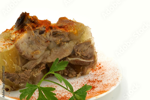 Traditional Romanian homemade pork trotter jelly dish called piftie. Jellied pork aspic made with pork meat served with paprika and fresh parsley.