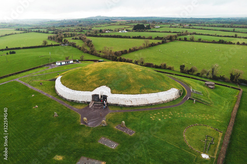 newgrange - old passage tomb in green field
