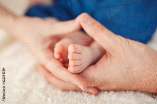 Close up photo of a baby foot in mother hands.