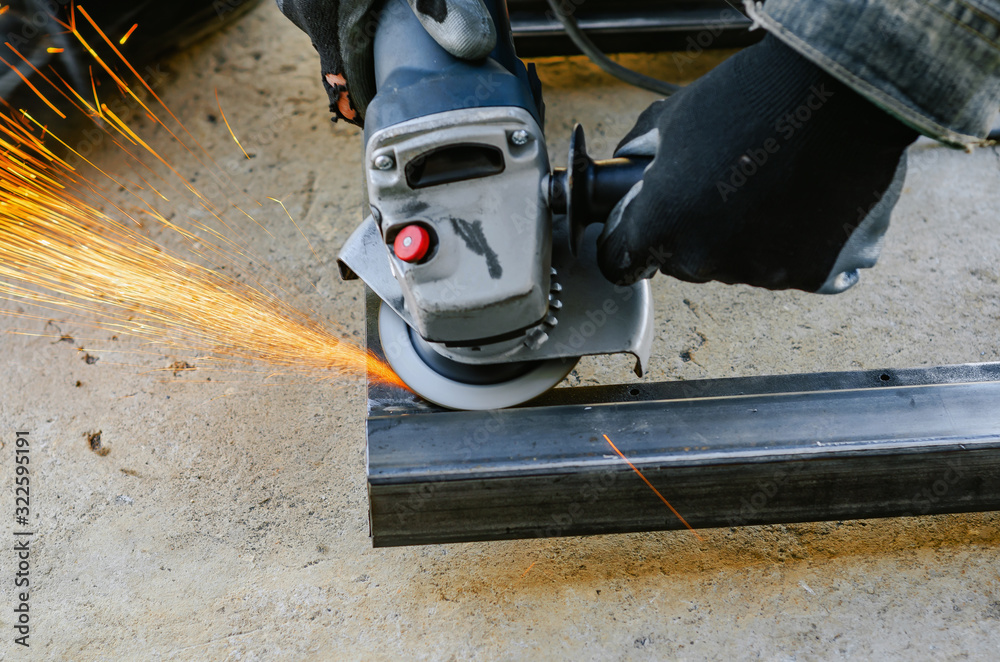 Metal cutting with an electric circular saw. Sparks fly Metal cutting with an electric circular saw. Sparks fly