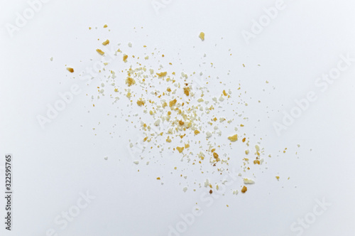 Scattered crumbs of cookies on white background.