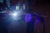 Metal welding in metal workshop. Clear light, blue tinting