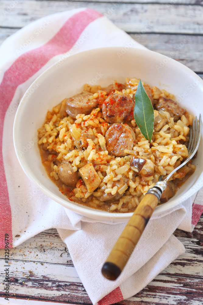 Regional Italian cuisine. Piedmontese risotto with porcini mushrooms and sausages Regional Italian cuisine. Piedmontese risotto with porcini mushrooms and sausages