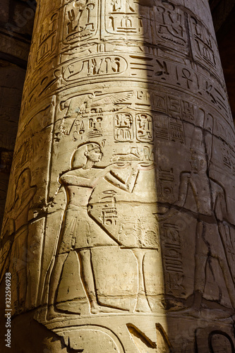 Egyptian ancient hieroglyphs on a columns in the great hypostyle hall of the Karnak temple
